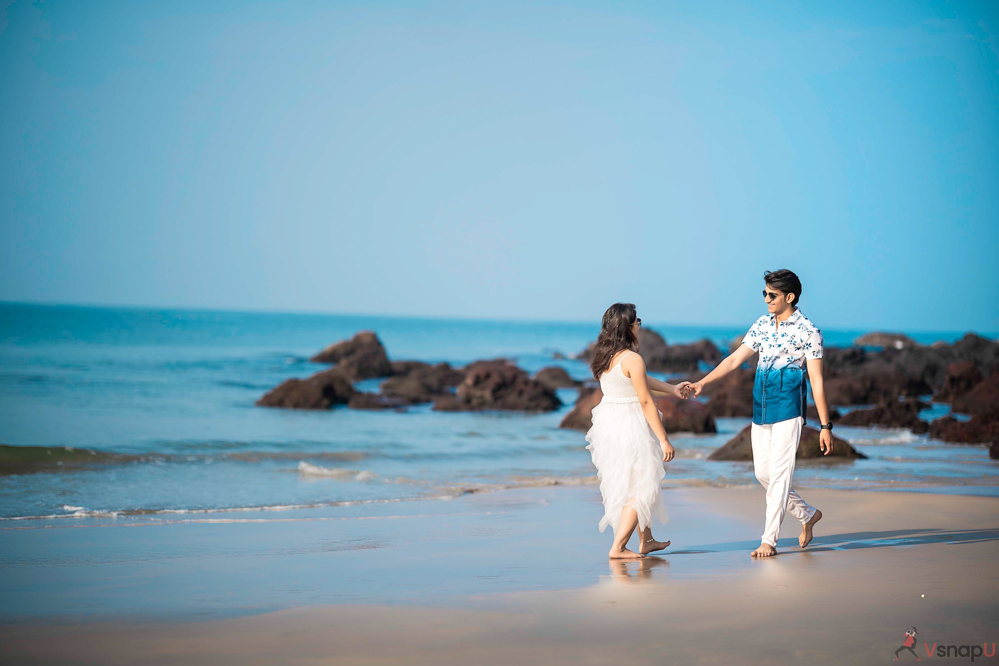 Romantic couple dancing in the sand during beach shoot